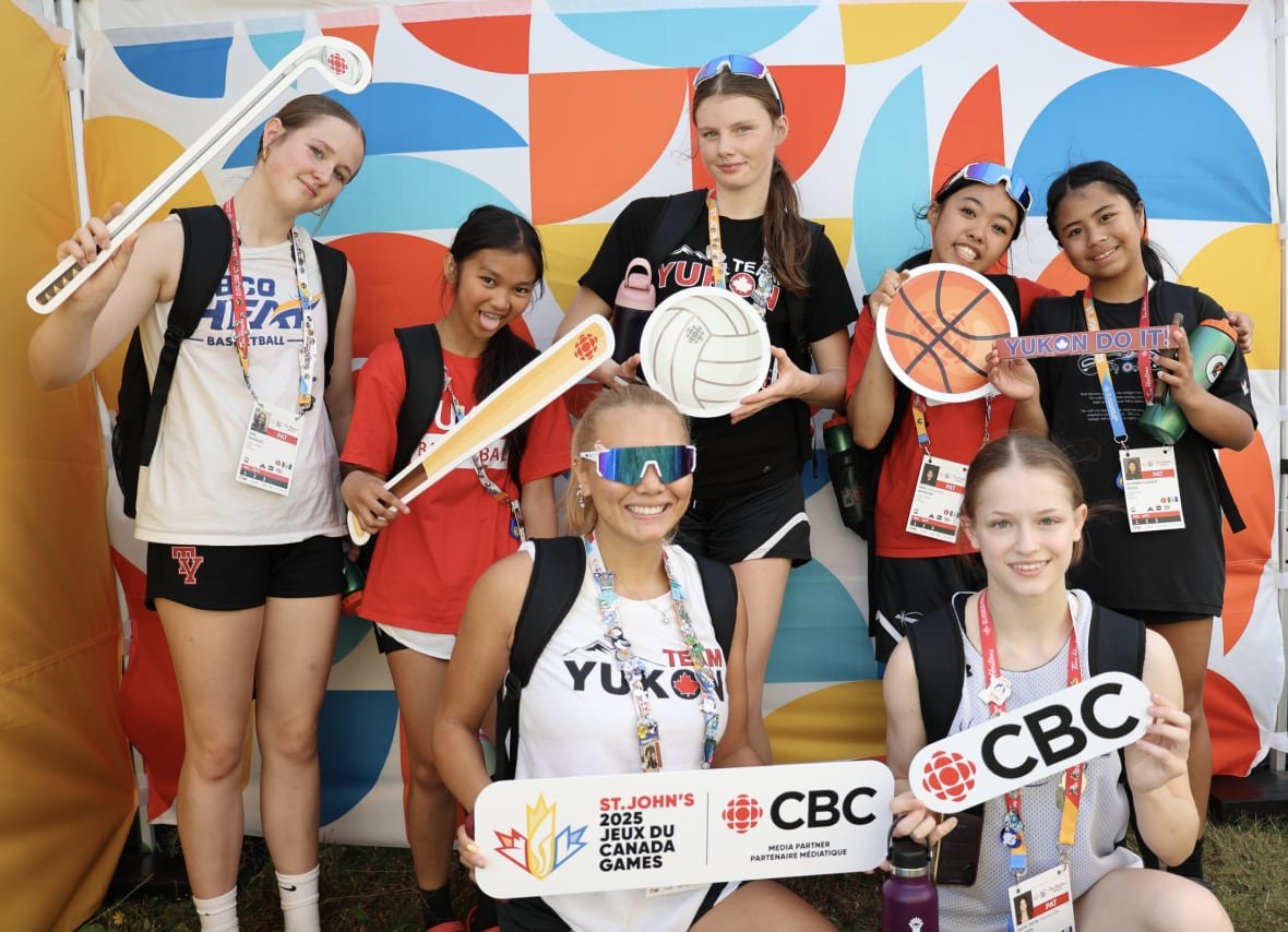 Female athletes posing with props at the CBC Pop-Up Photo Studio during the 2025 Canada Games.