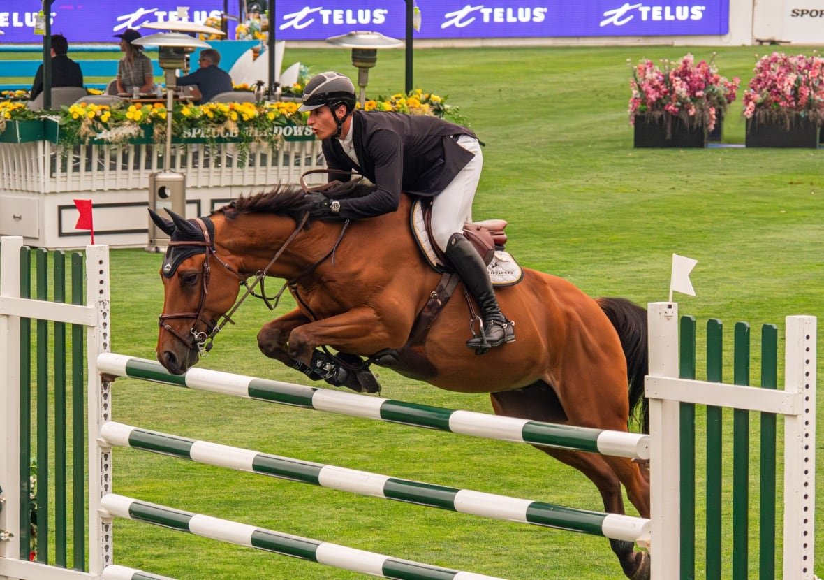 A show jumping team navigating an obstacle at Spruce Meadows, a sports and entertainment venue located in the southern outskirts of Calgary.