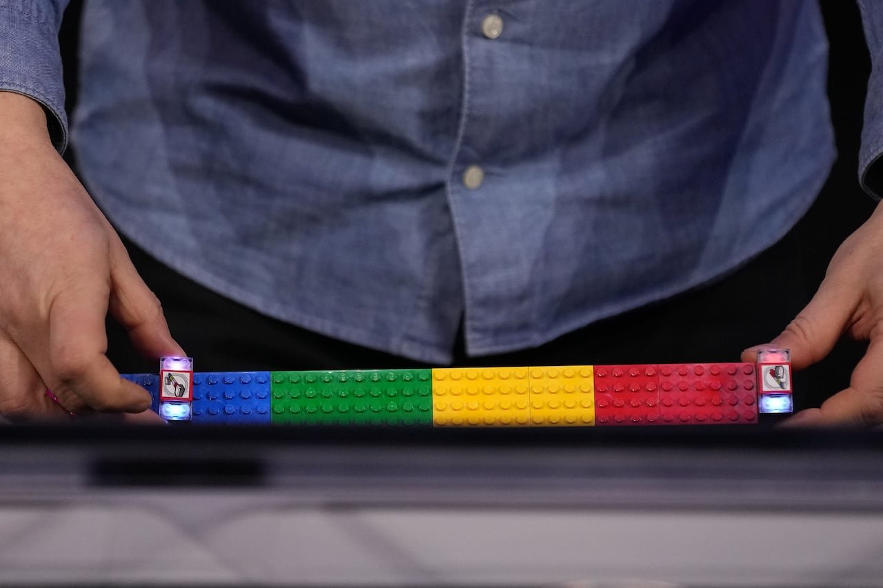 default-209 A person demonstrating smart LEGO bricks on stage.